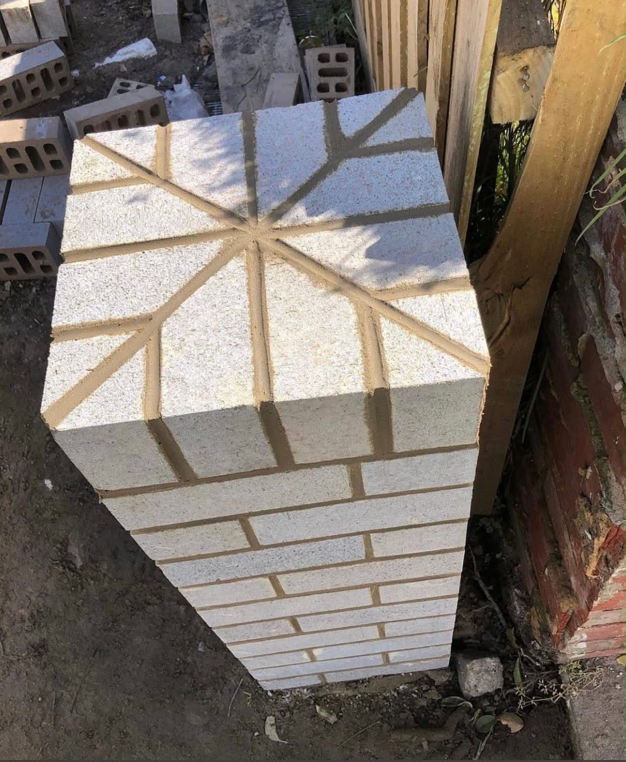 Carved column cap with star pattern in heritage brickwork