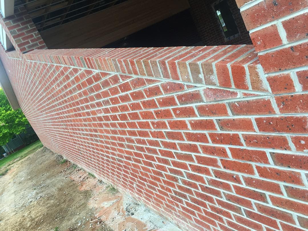 Chamfered red-brick corner detail with clean returns