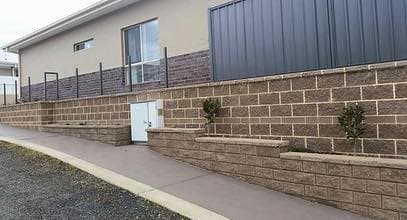 Modern split-face block retaining wall with picket cap