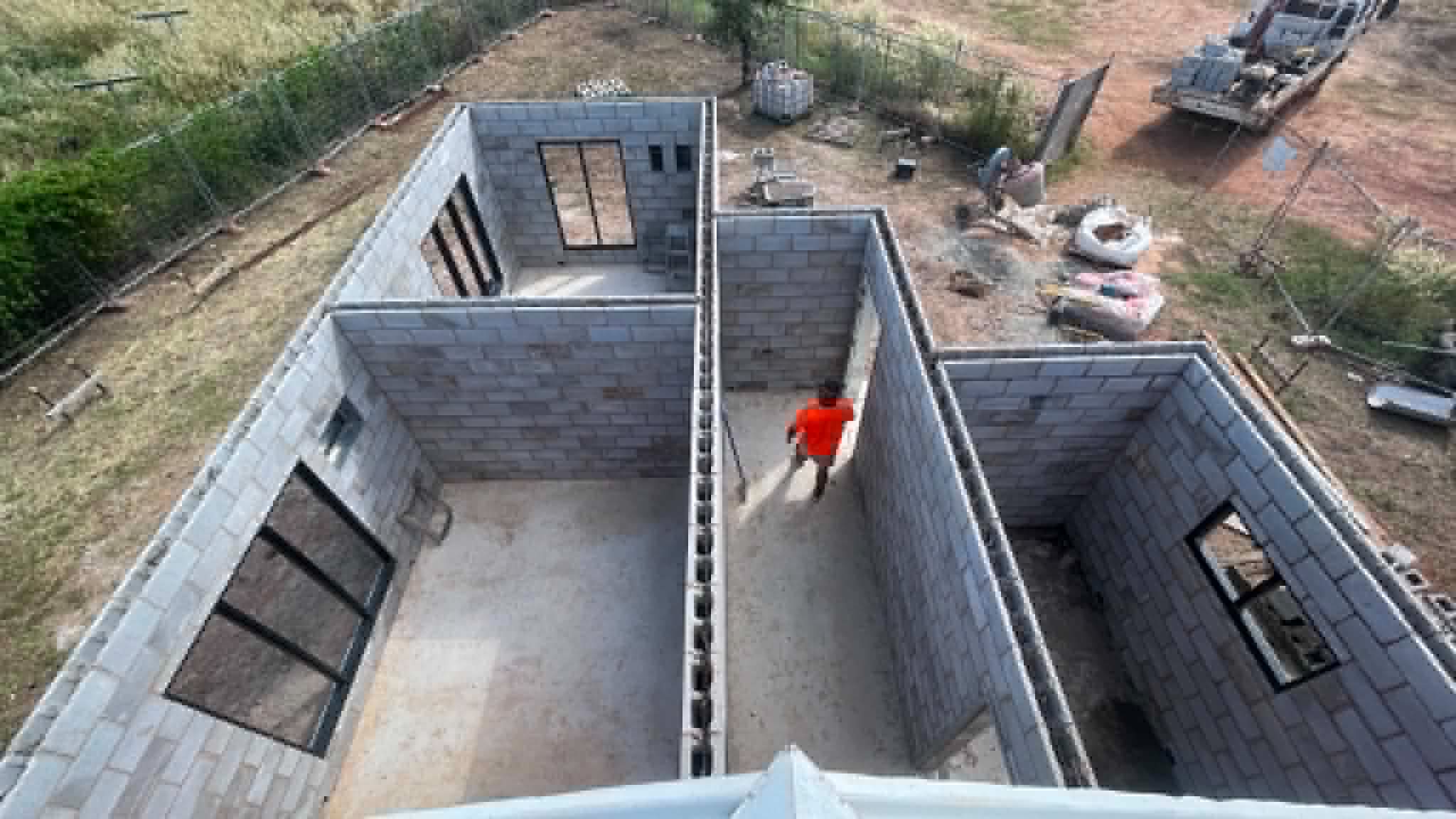 Aerial of a block-built home with walls up on a Palmerston-area block.