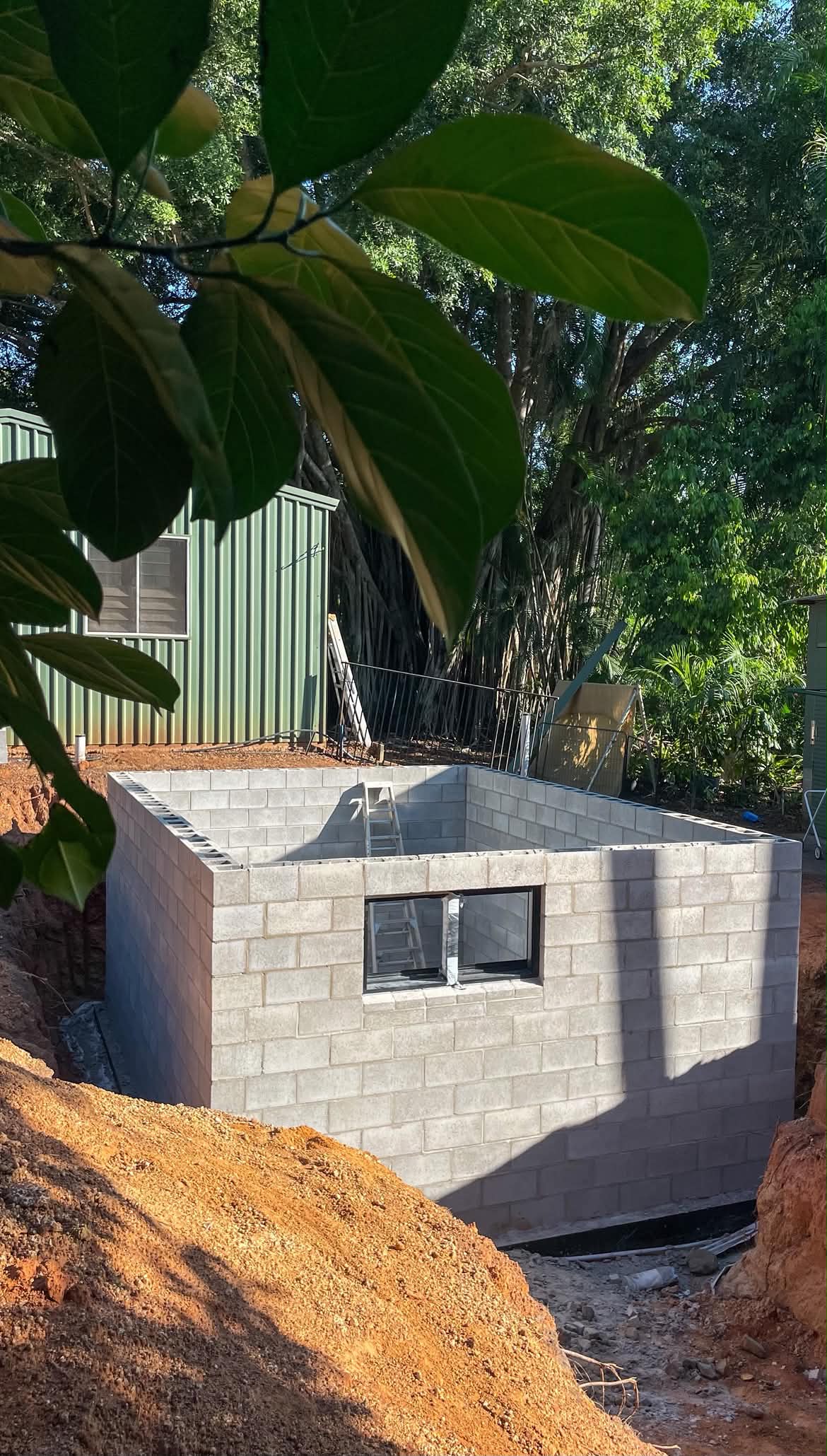 Core-filled grey besser block structure under construction in the Top End, reinforcement visible at the top course.